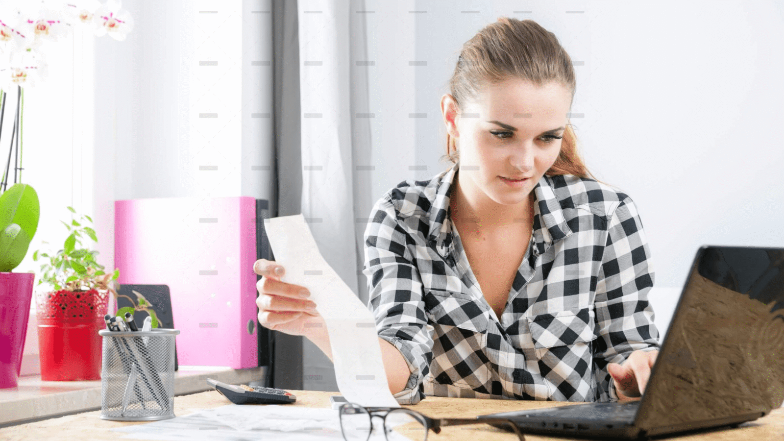 demo-attachment-2817-Smiling-young-woman-calculabting-and-paying-bills-in-home-office-4-39051-original-protected-scaled